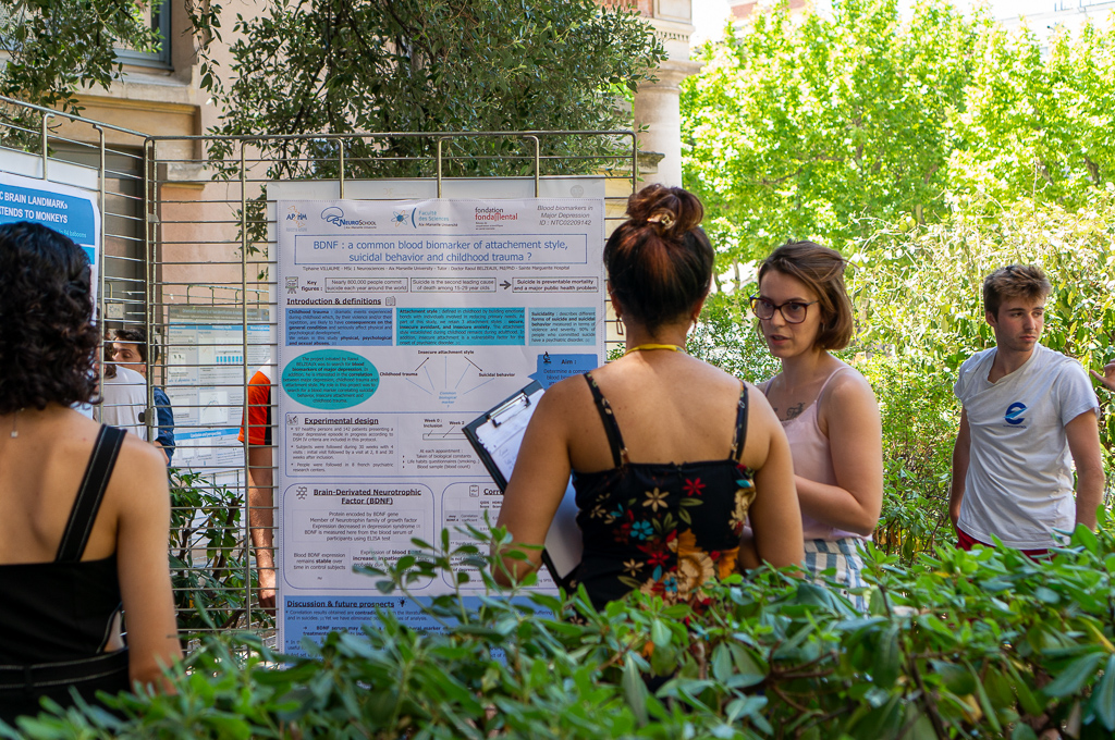 Une étudiante et une jurée discutent devant un poster lors de la présentation des posters de M1